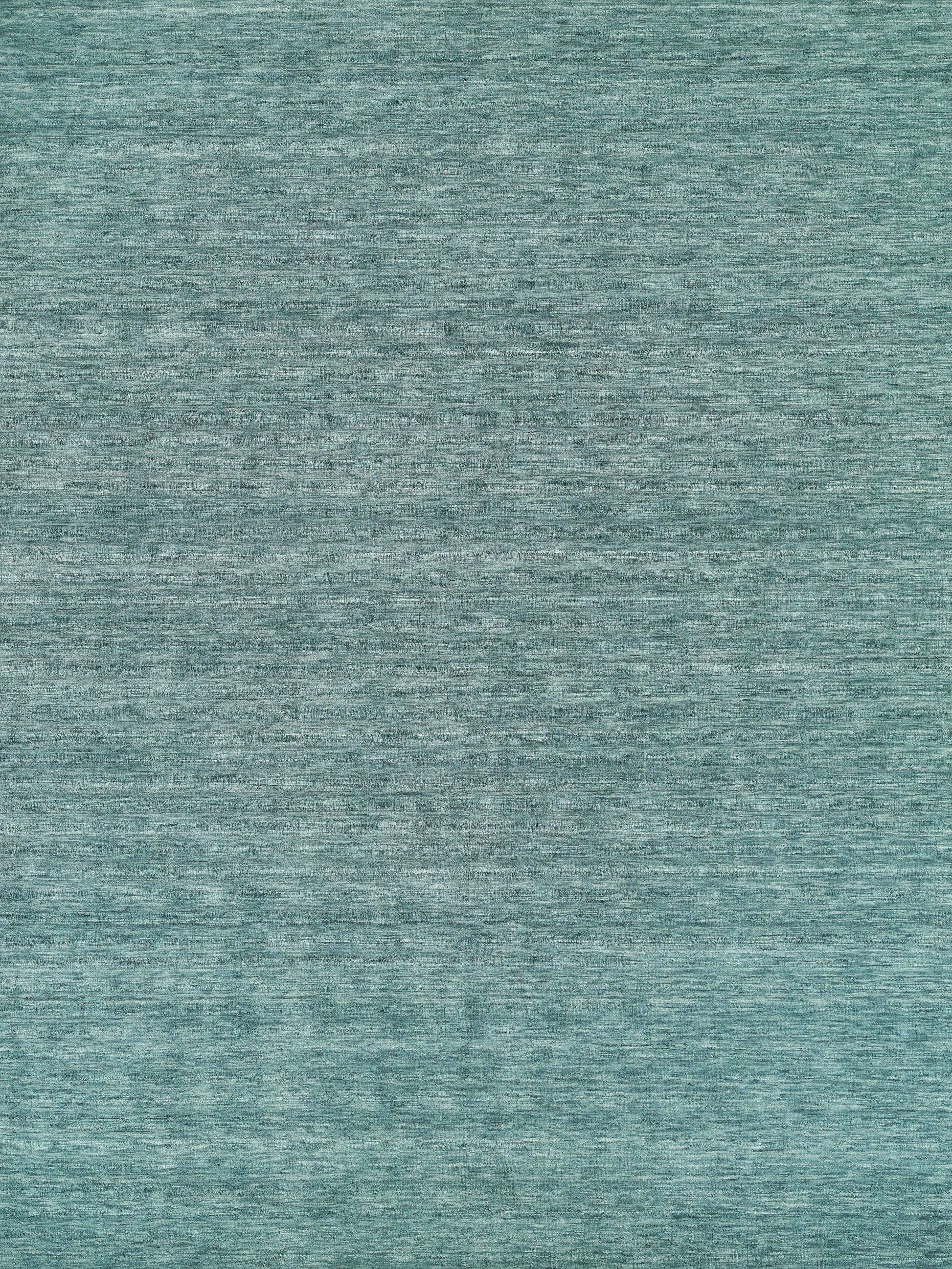 Teal heathered hand-loomed rug with subtle melange fibers; soft and cozy.