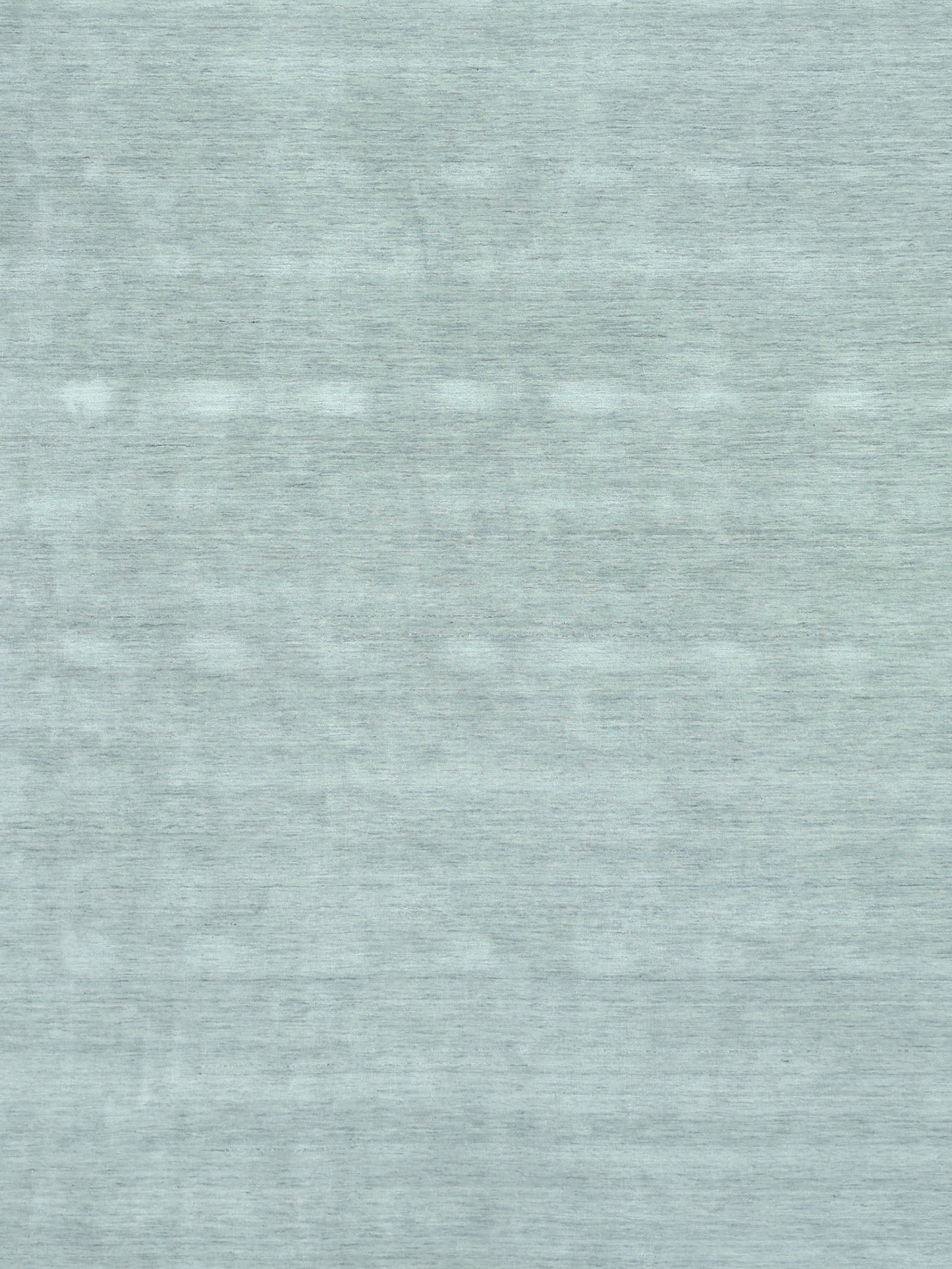 Close-up of a light blue heathered rug texture; soft, versatile rug for home decor.