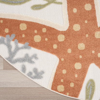 Orange rug with cream polka dots and pale blue botanical accents along a light border on a wooden floor