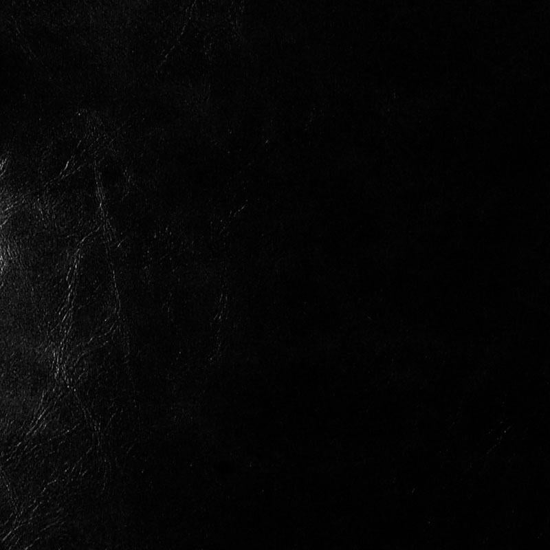 Close-up of ebony upholstery fabric with a subtle weave texture and slight sheen.