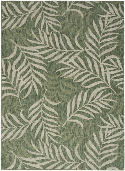 Green textured area rug with white palm leaf pattern, tropical botanical design.