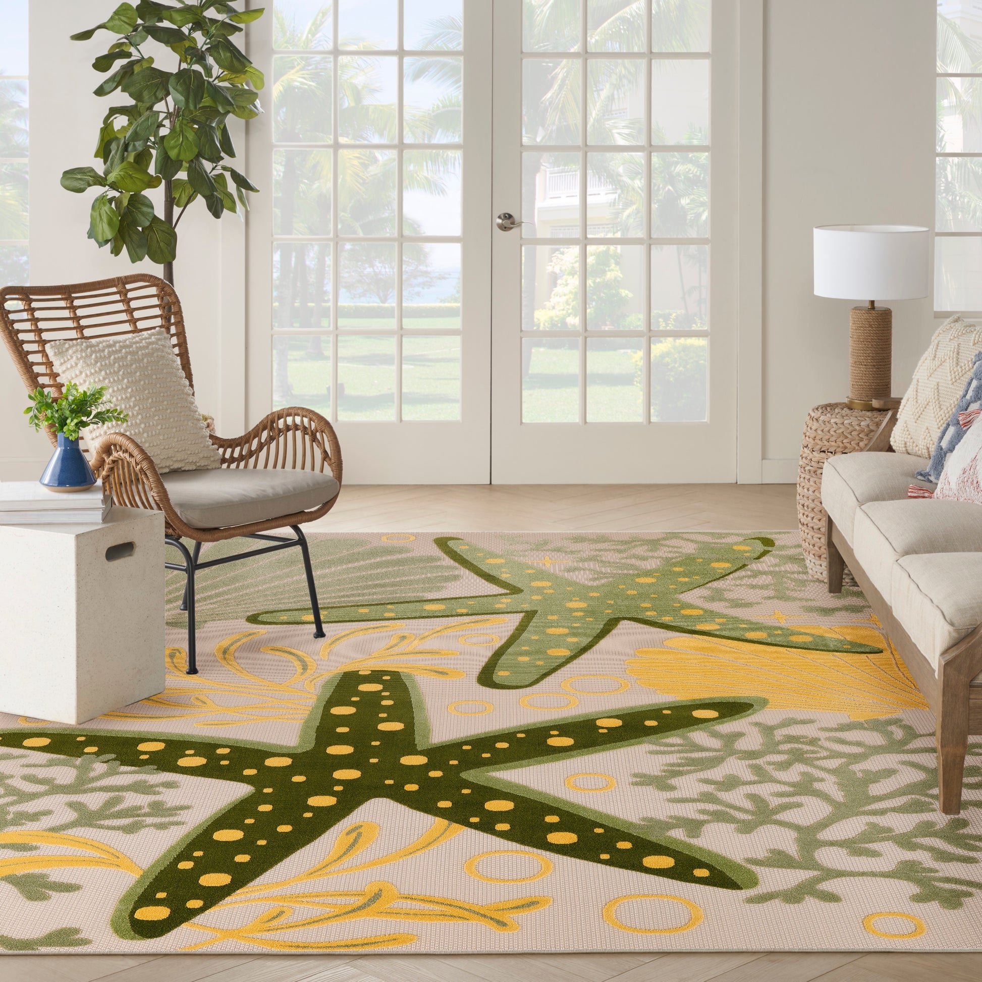 Coastal outdoor rug featuring dark green starfish shapes with yellow dots.