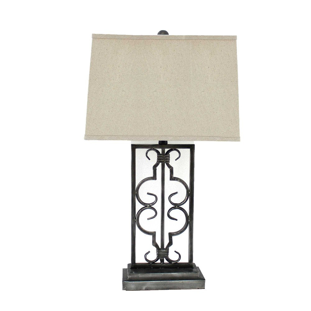 Black metal table lamp with decorative scrollwork base and beige rectangular fabric shade.
