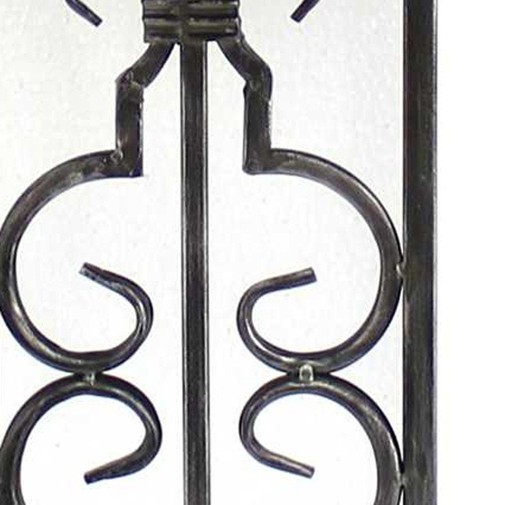 Wrought iron decorative gate panel with symmetric scrollwork, black metal, vintage fence railing.