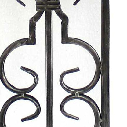 Wrought iron decorative gate panel with symmetric scrollwork, black metal, vintage fence railing.