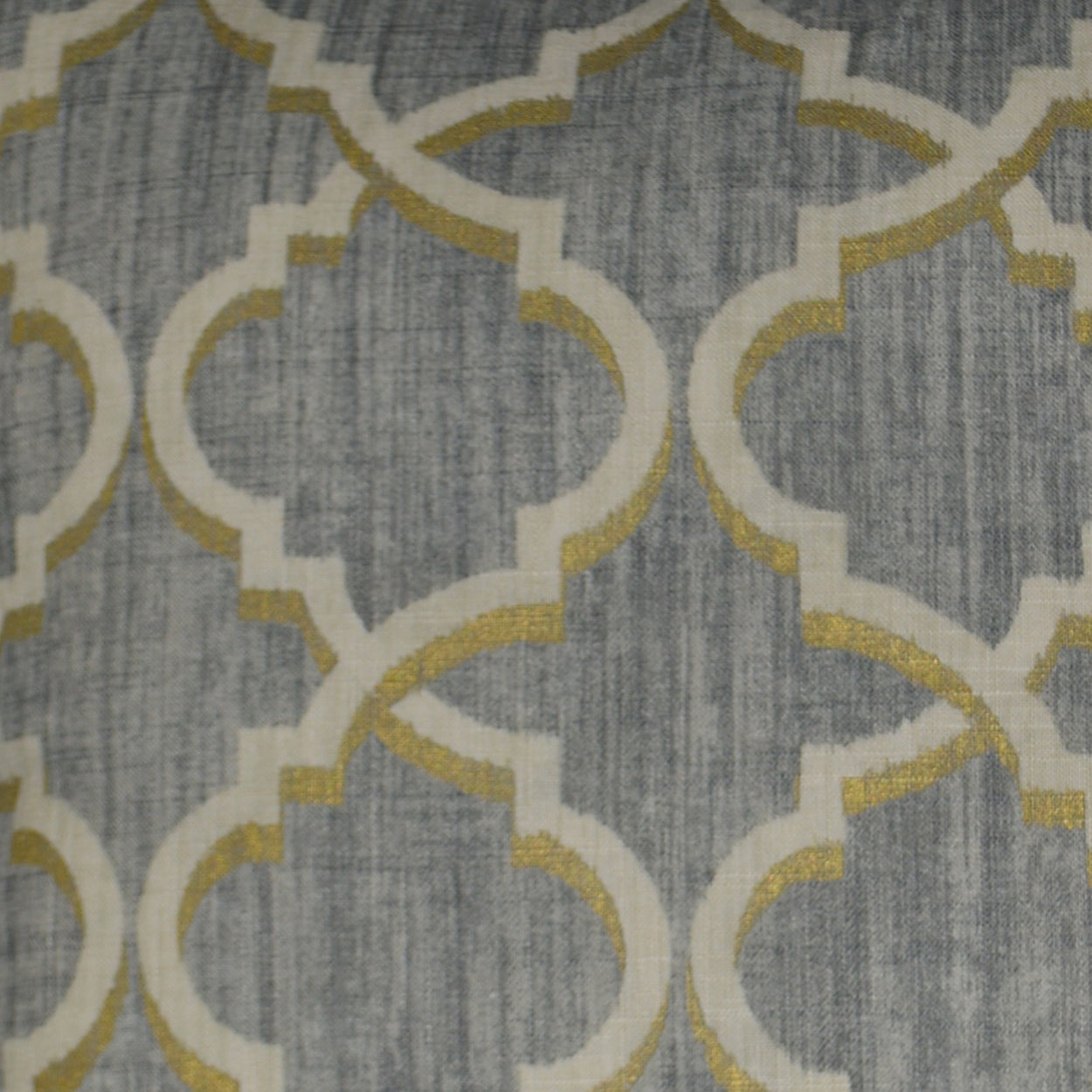 Grey woven fabric with white interlocking quattrofoil lattice outlined in gold, modern geometric pattern.