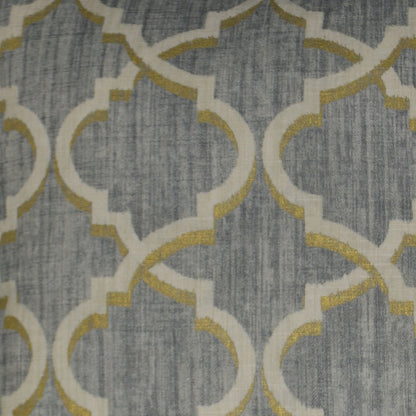 Grey woven fabric with white interlocking quattrofoil lattice outlined in gold, modern geometric pattern.