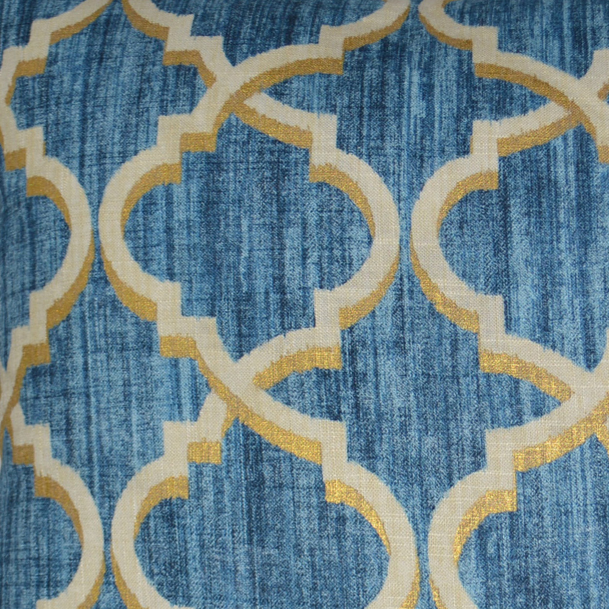 Indigo woven pillow & gold interlocking lattice shapes in a Moroccan-style motif.