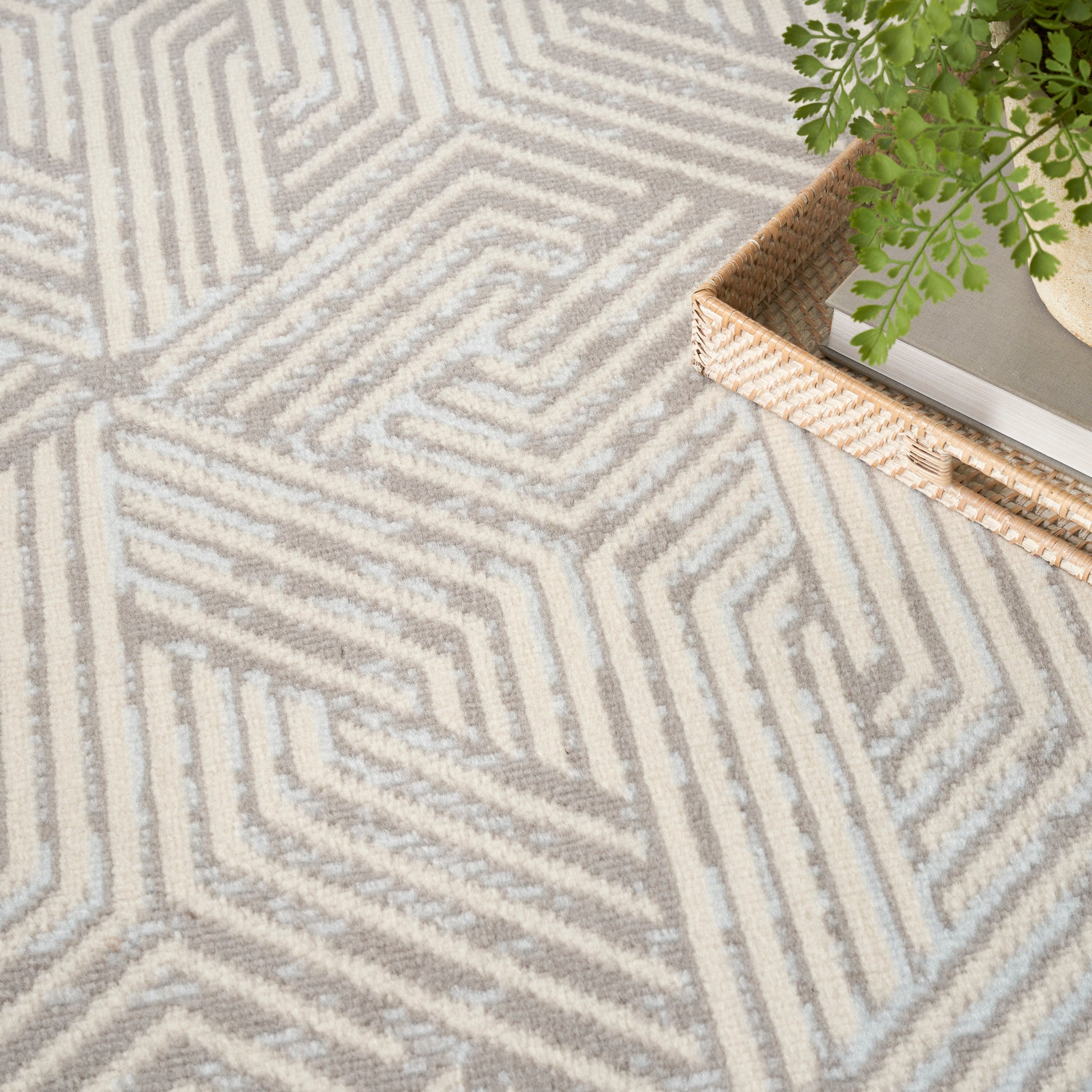 Light gray and beige geometric textured rug; modern contemporary style for living spaces.