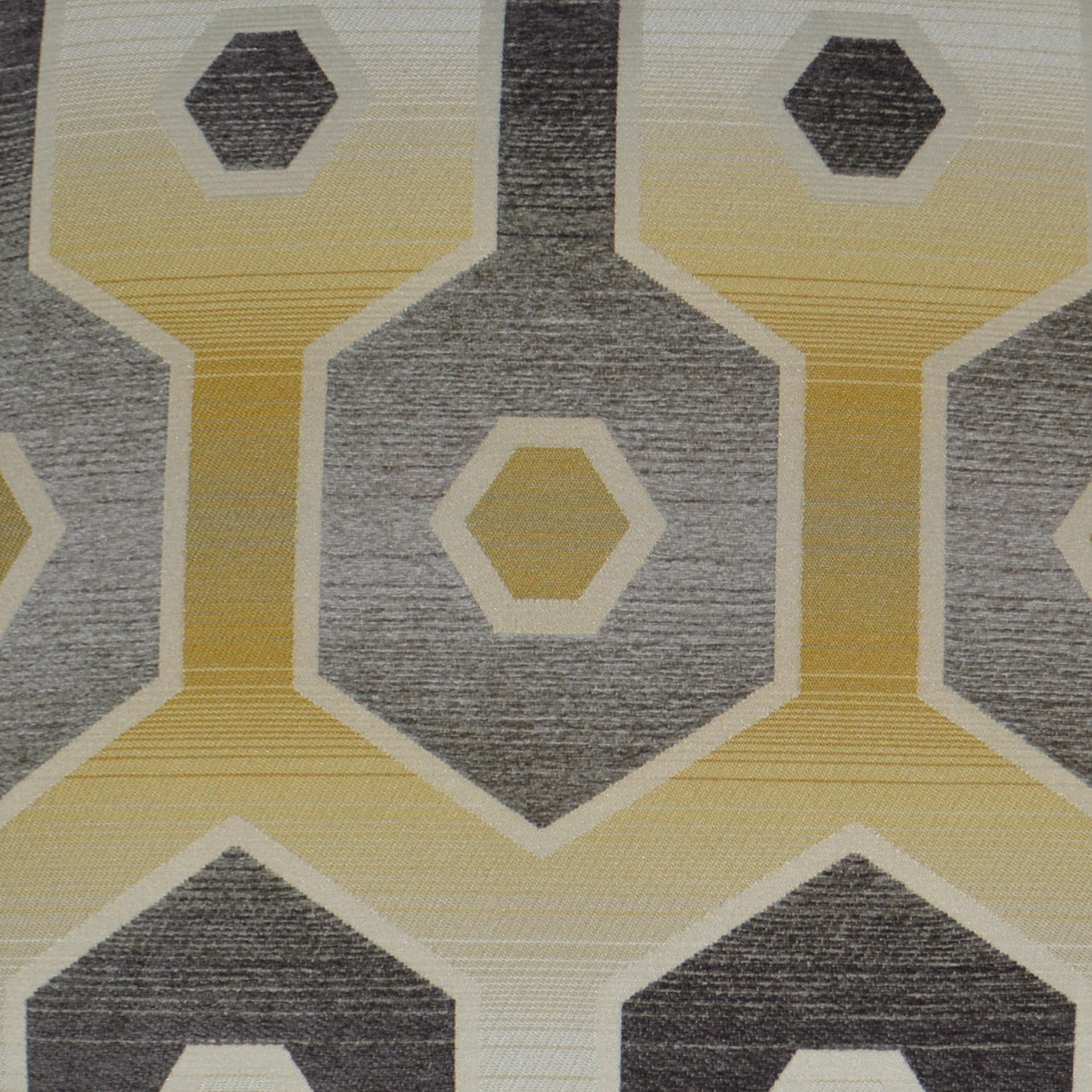 Geometric honeycomb fabric pattern with yellow-gold hexagons outlined in cream on a gray woven background.