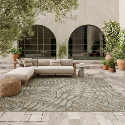 Tropical 6' x 9' rug with a leaf pattern in an outdoor Mediterranean courtyard setting.