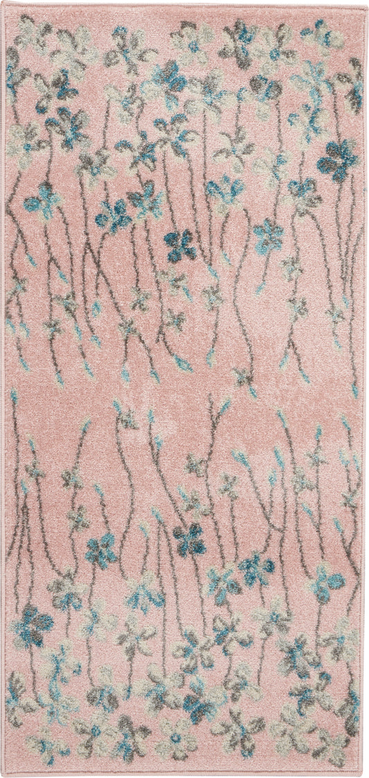 Soft pink floral area rug with blue and white blossoms along slender gray stems.
