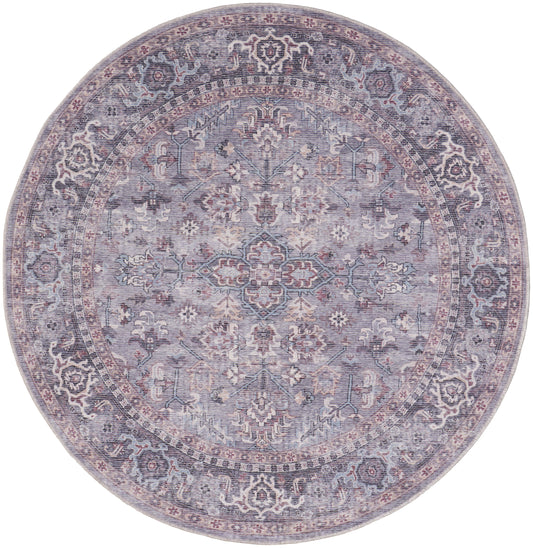 Round Persian-style rug in lavender-gray with pastel pink accents; intricate floral medallion center, vintage distressed finish.
