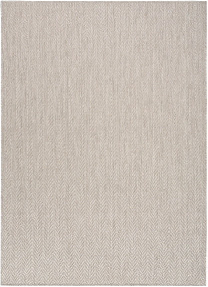 Beige herringbone woven area rug with soft, neutral tones and subtle texture.