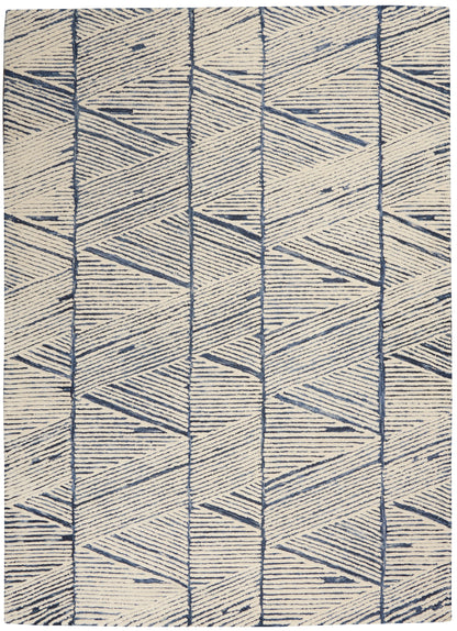 Beige woven rug with navy geometric triangles and chevrons, a modern abstract pattern for living room decor.
