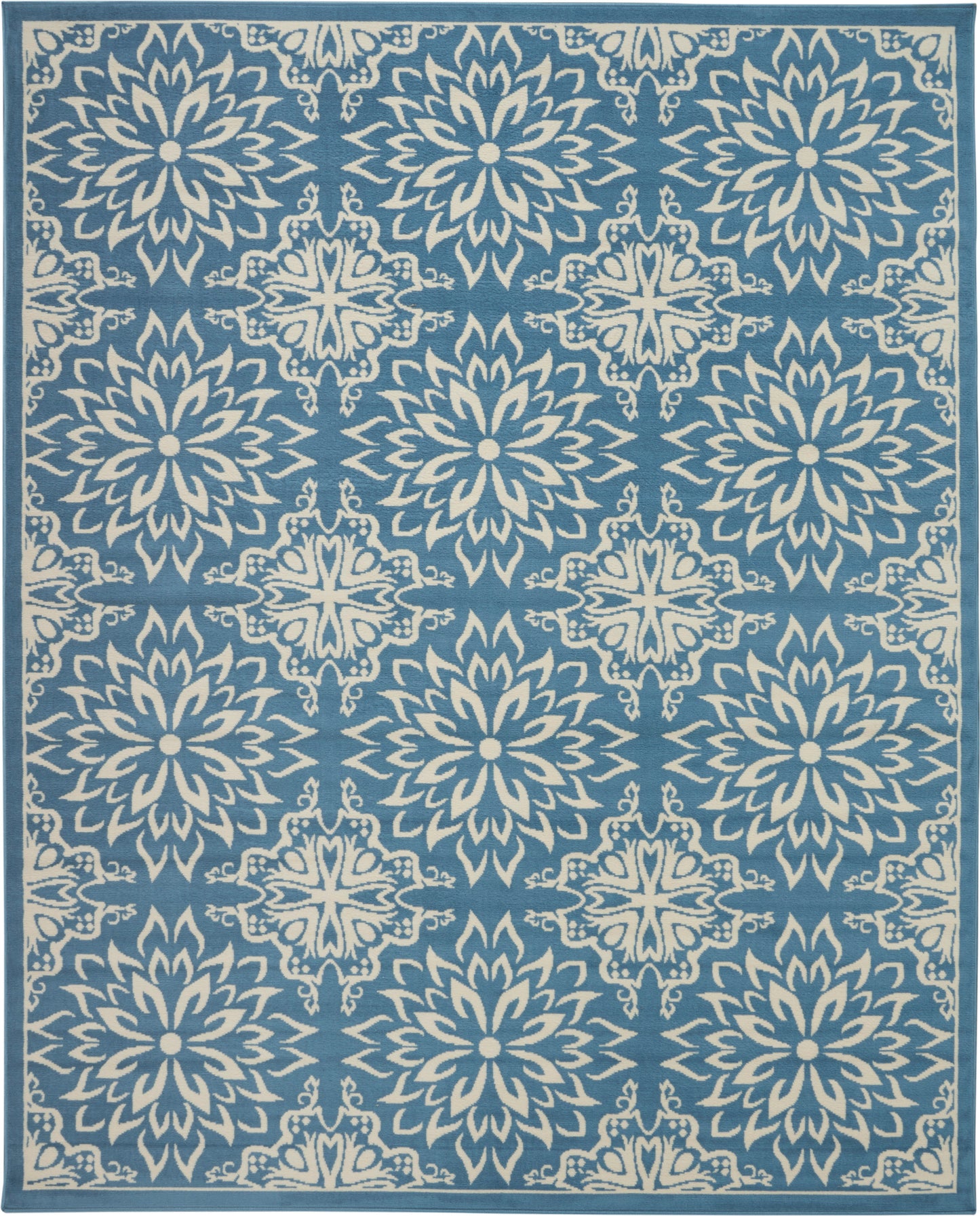 Blue area rug with white starburst floral medallions in a repeating pattern and bordered edges.