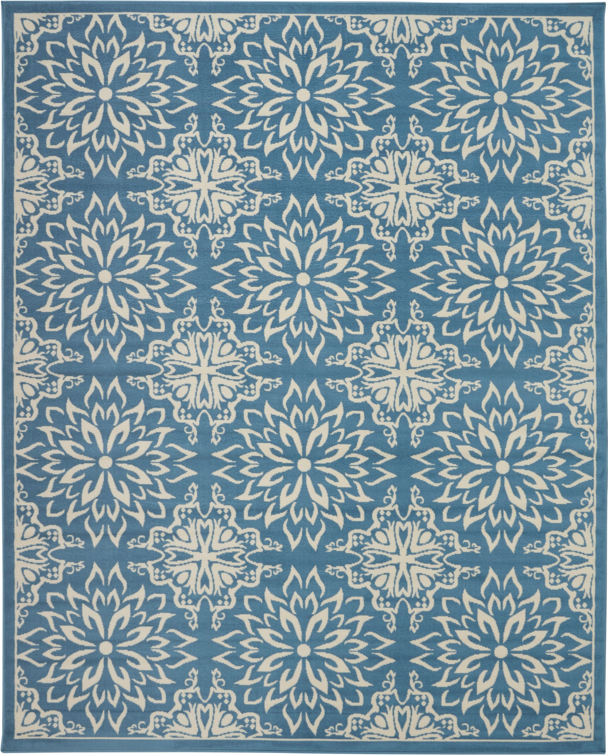 Blue area rug with white starburst floral medallions in a repeating pattern and bordered edges.