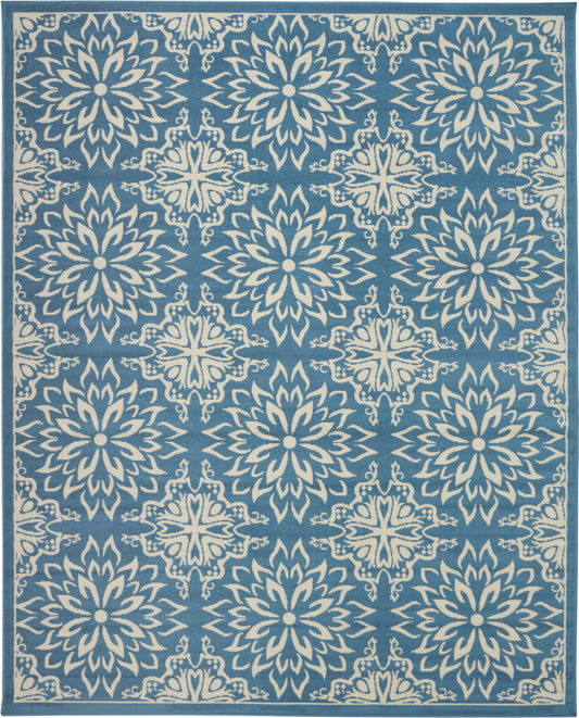 Blue area rug with white starburst floral medallions in a repeating pattern and bordered edges.