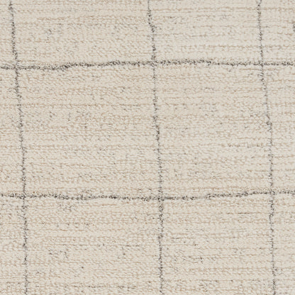 Cream shag rug with boucle texture and gray grid lines forming large squares; neutral, modern living-room rug.