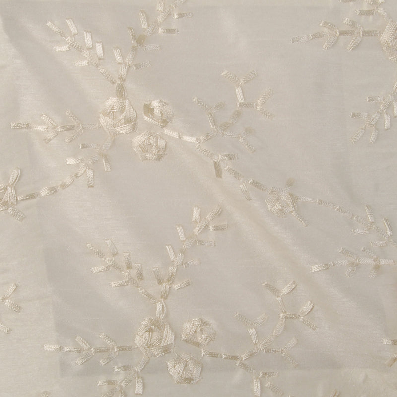 Ivory fabric with white embroidered floral vine pattern; delicate leaves & blossoms.