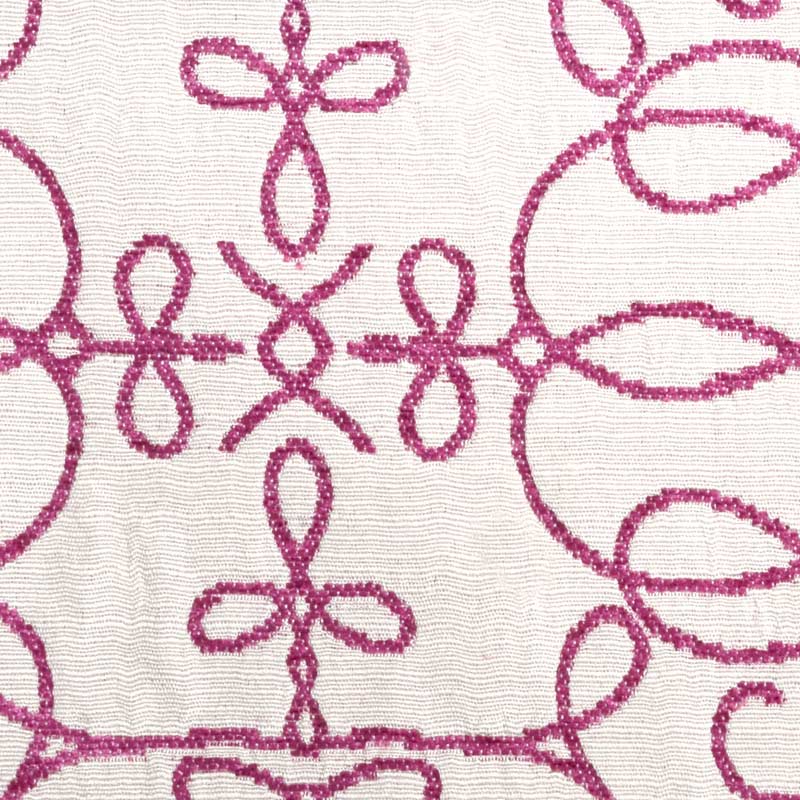 Pink upholstery fabric with magenta embroidered geometric floral lattice; decorative textile pattern.