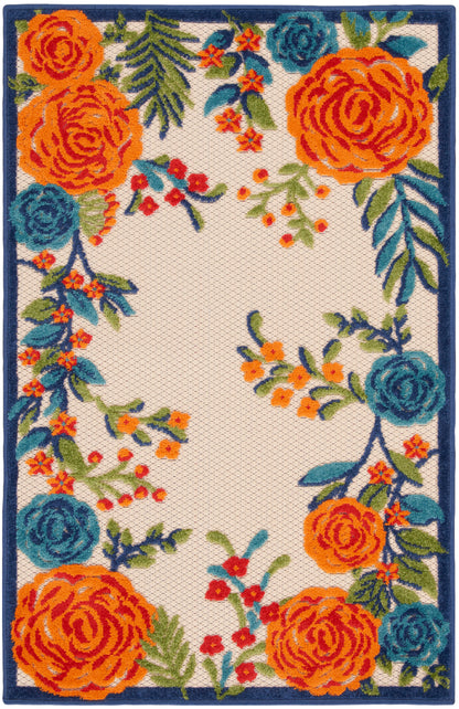 Rectangular floral rug with bold orange and teal roses and greenery along a navy border on cream background.