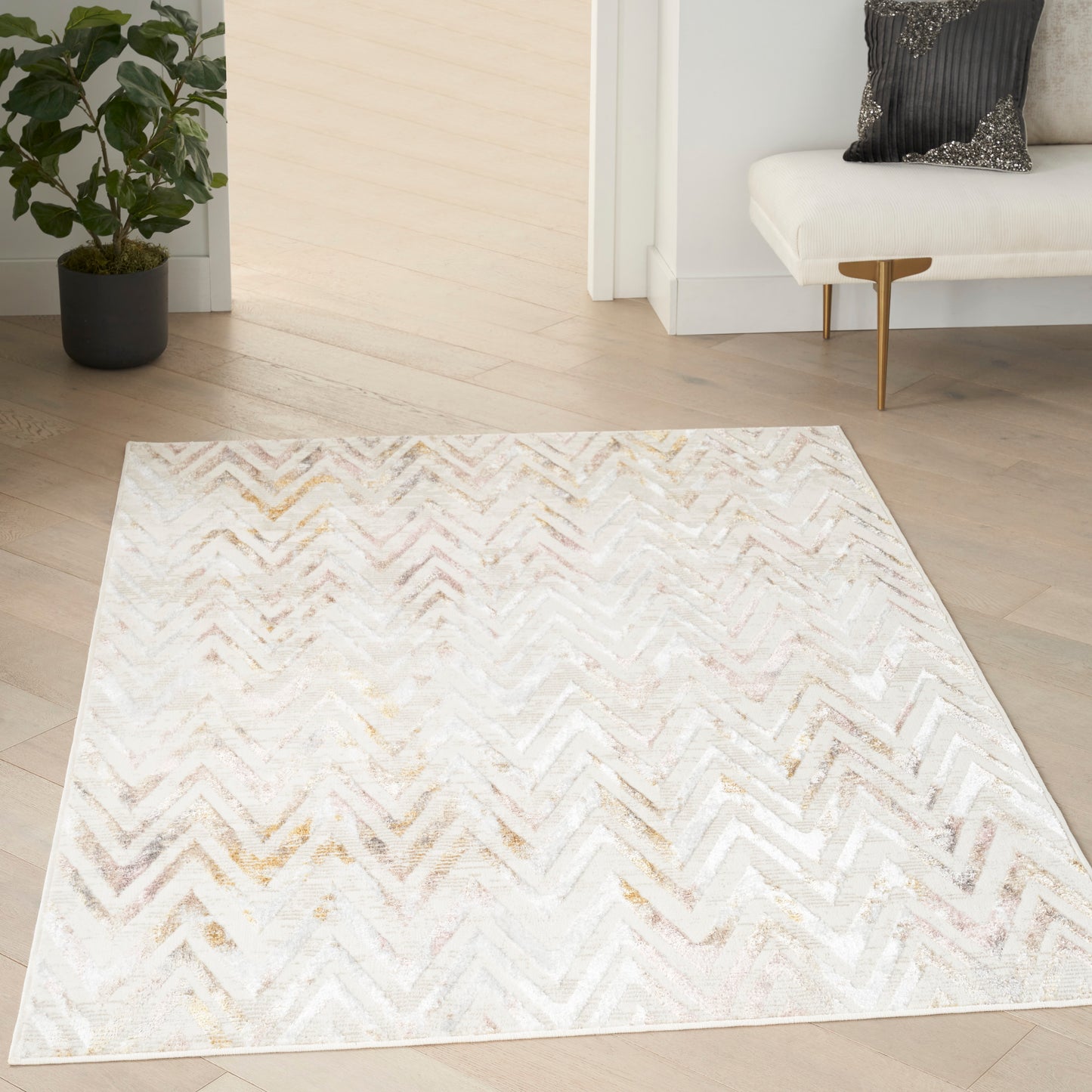 Rectangular cream chevron rug with subtle gold & gray tones, plush texture on light wood floor in a modern living room
