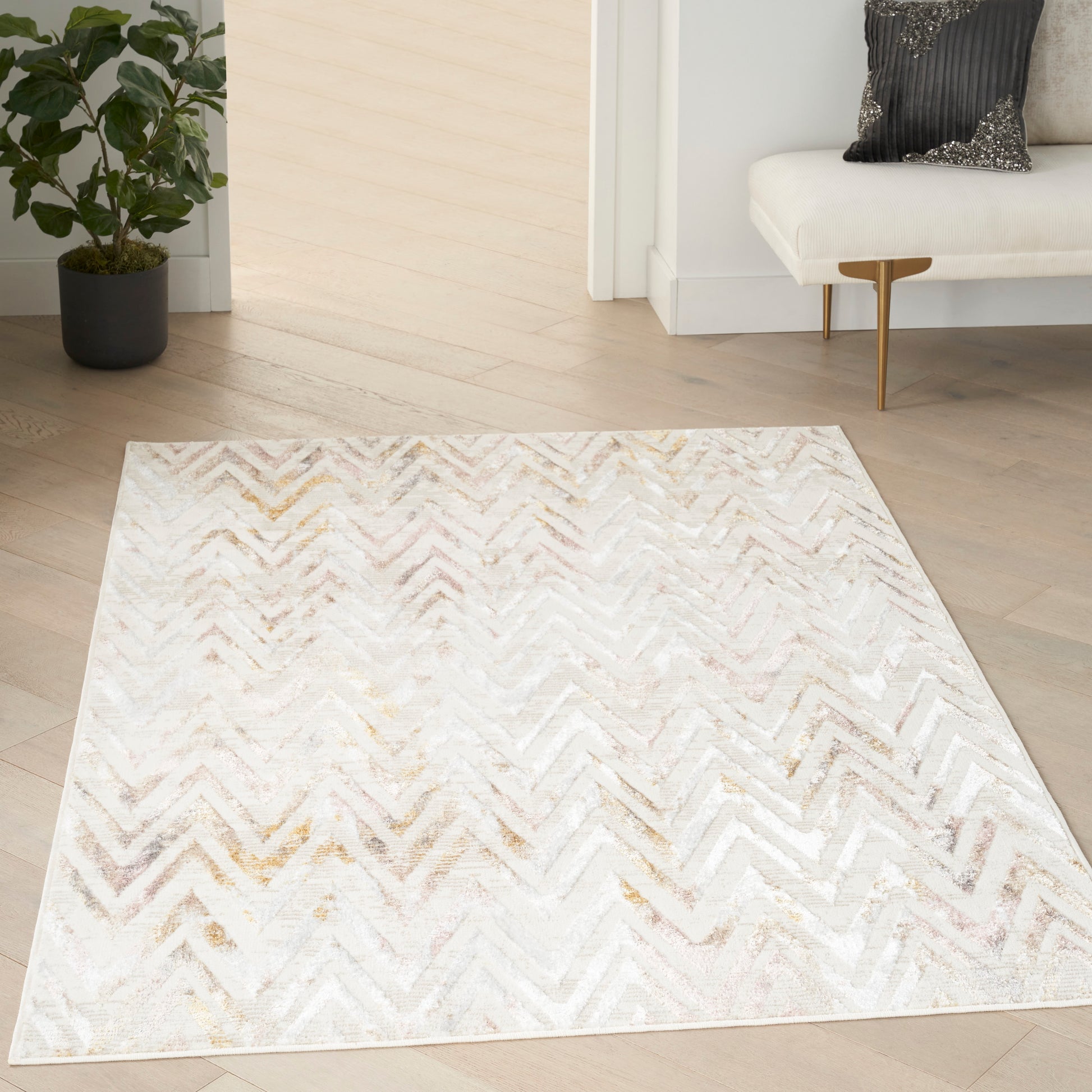 Rectangular cream chevron rug with subtle gold & gray tones, plush texture on light wood floor in a modern living room