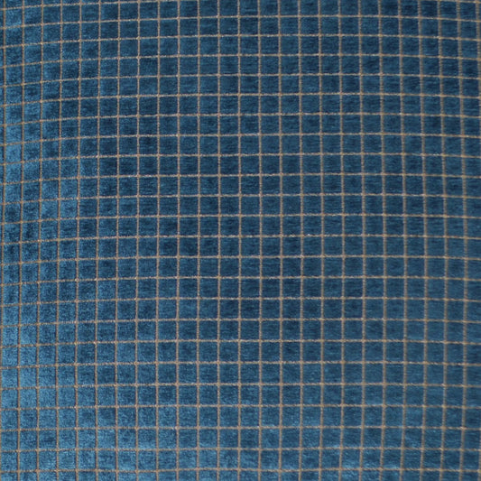 Blue fabric with a beige grid pattern of small squares, denim-inspired textile.