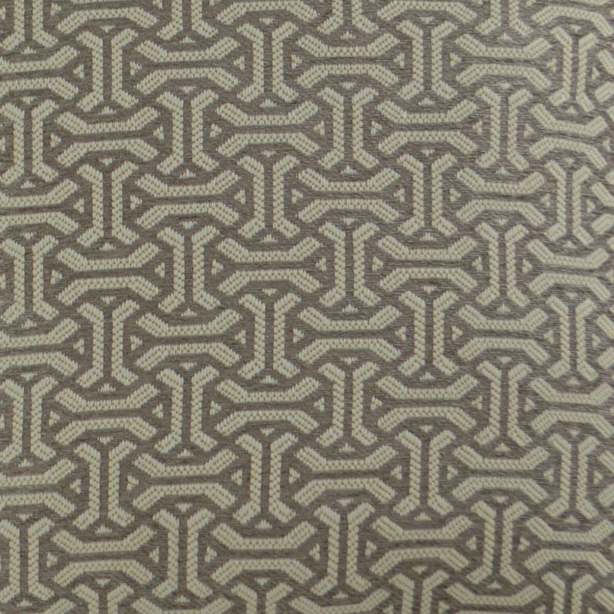 Beige-brown woven fabric with repeating interlocking chain motif; geometric upholstery or drapery material.