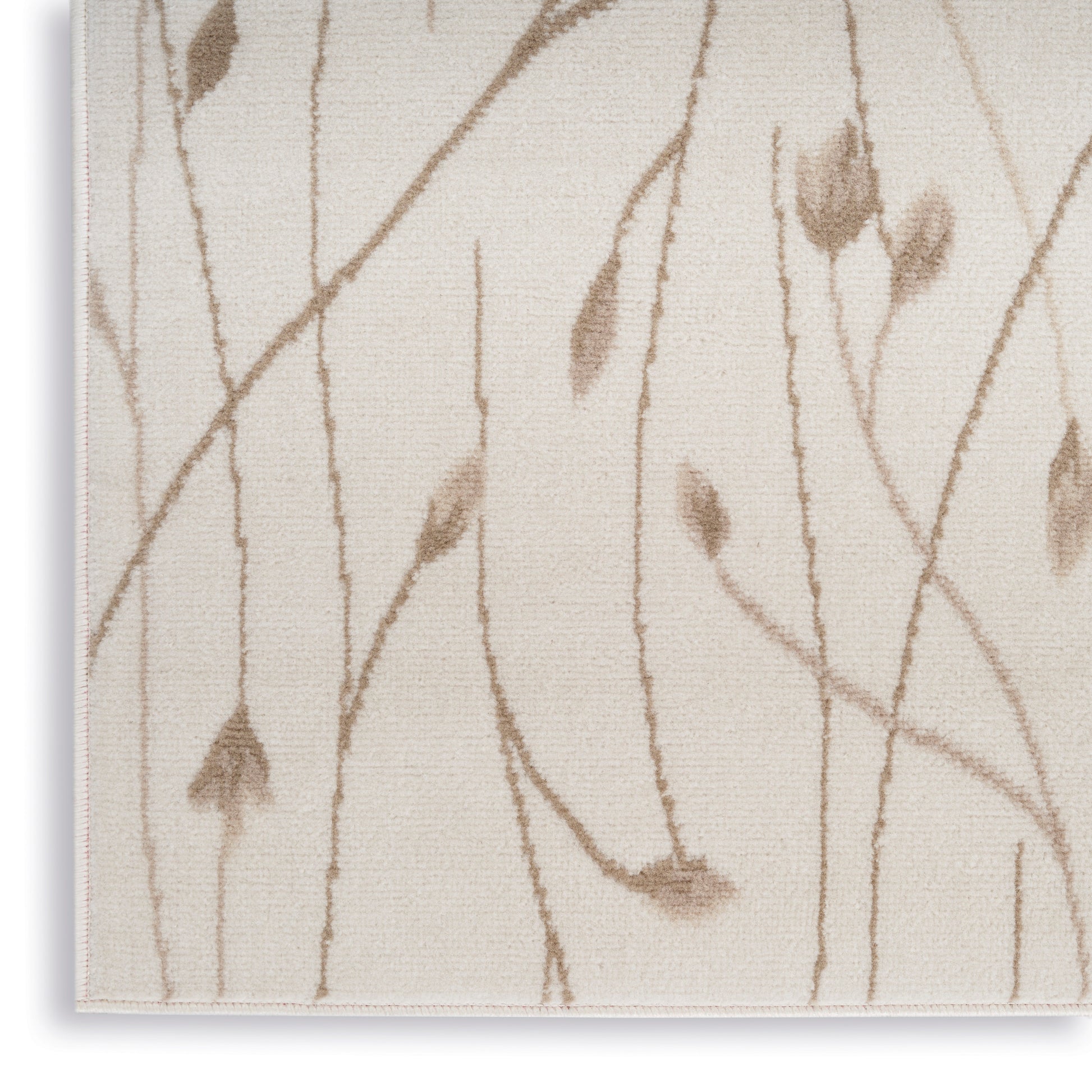 Beige woven rug with brown botanical vine and leaf motif; neutral natural decor.