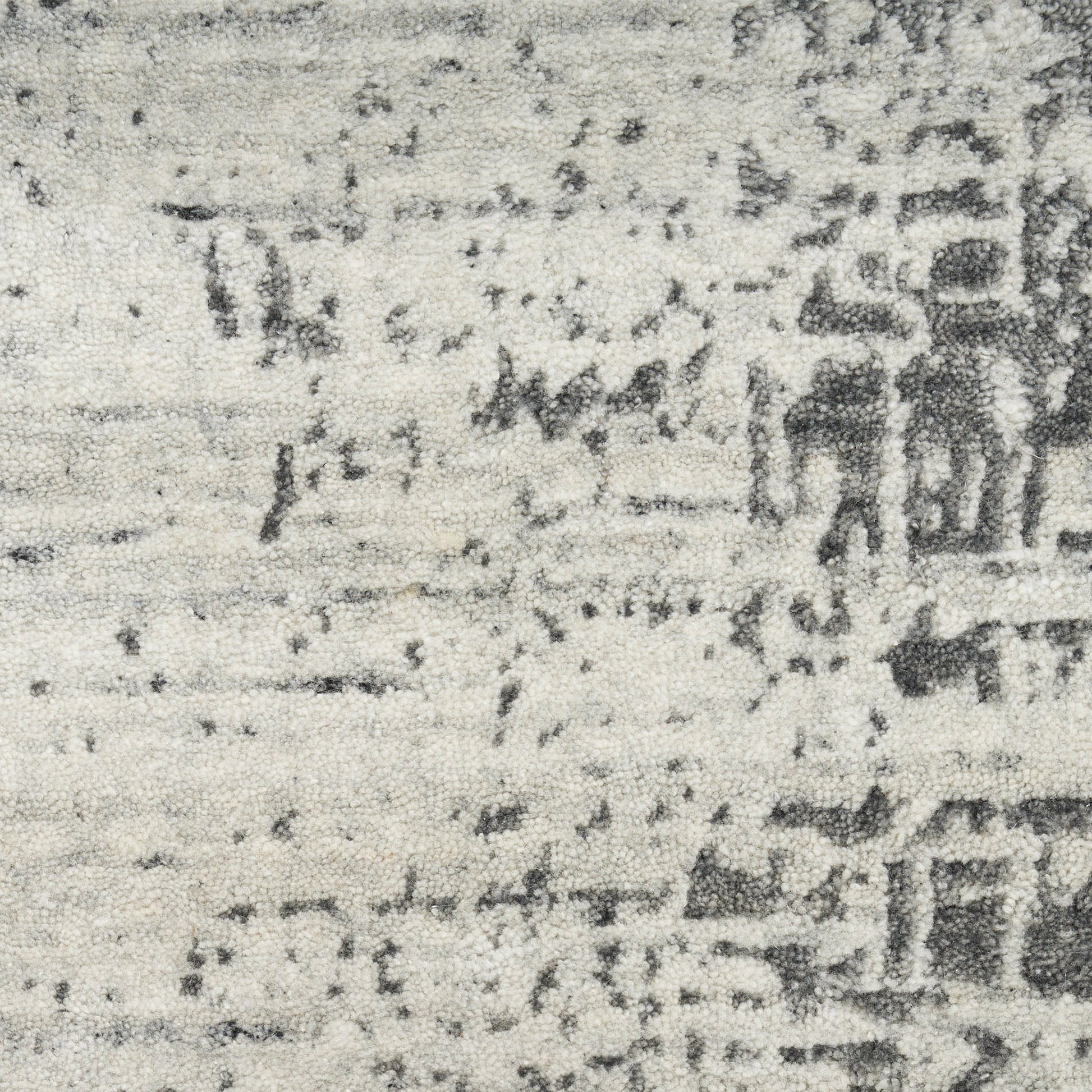 Grayscale close-up of a textured rug surface with speckled, mottled shading and faint horizontal lines, modern 8' x 10' rug.