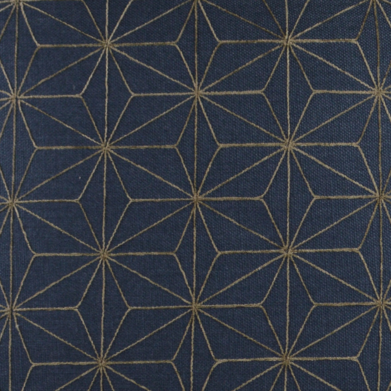Navy pillow with a geometric nautical pattern and gold metallic accents; 24" x 24" square.