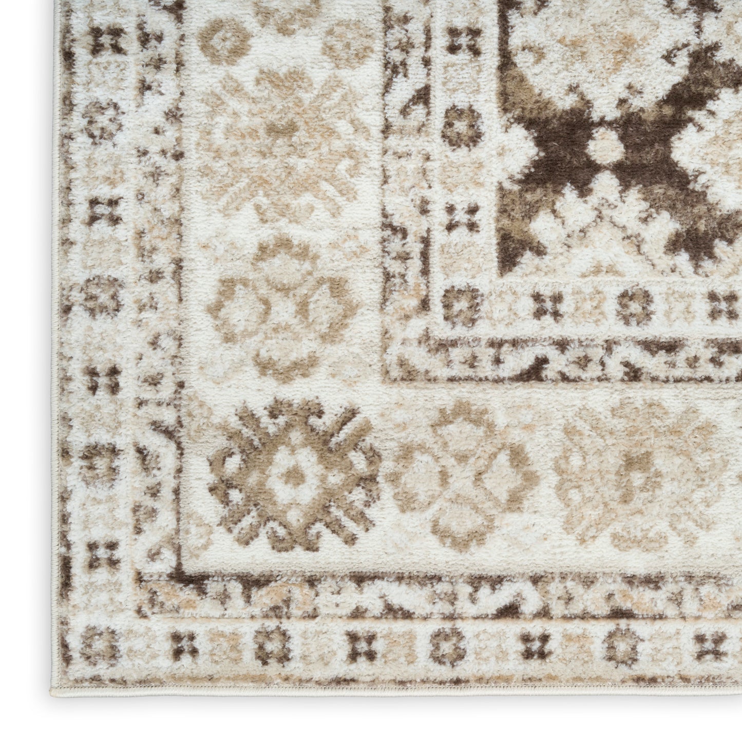 Rectangular beige ivory area rug with brown oriental pattern, floral medallions, shaggy texture and border.