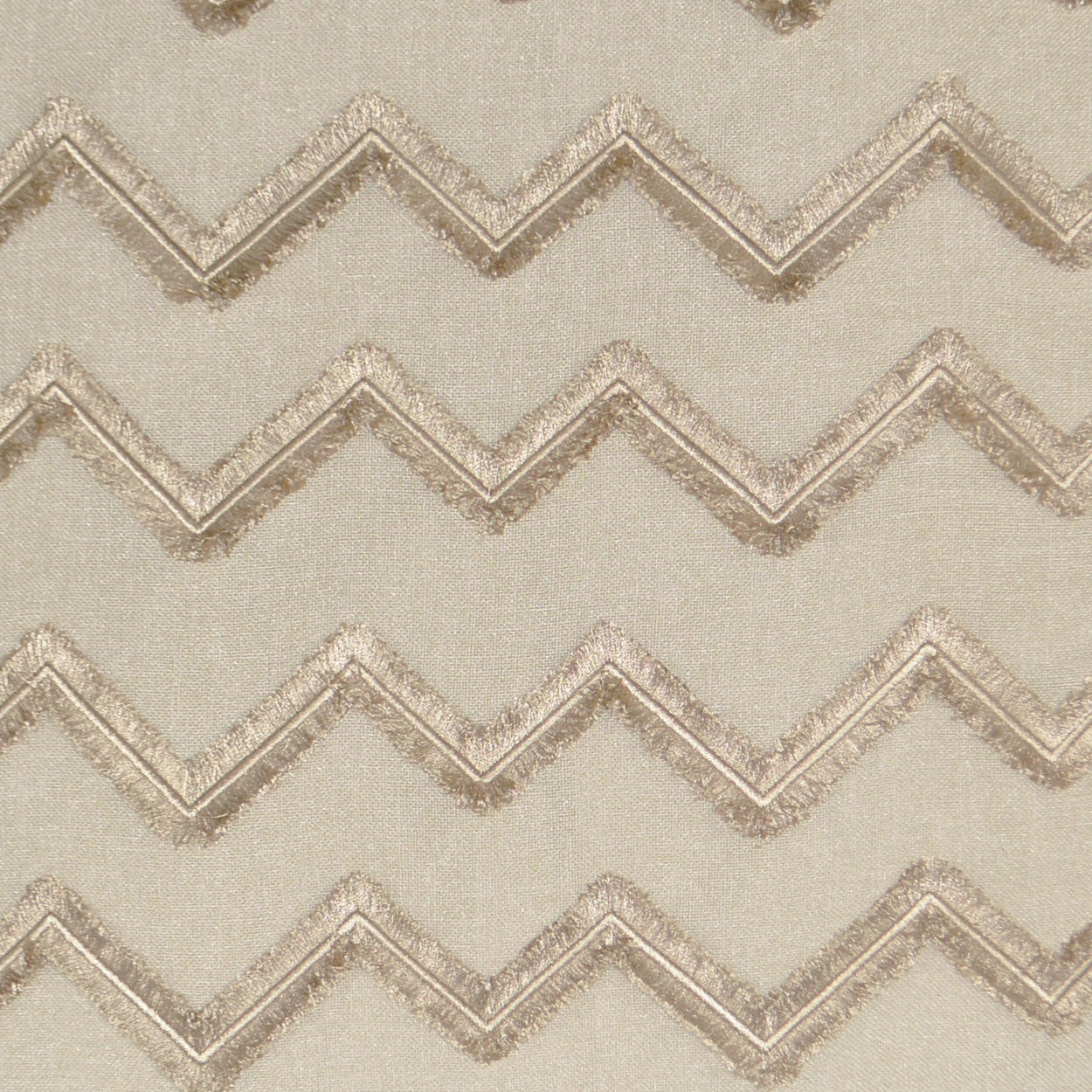 Beige pillow with linen embroidery and textured chevron pattern; 24" x 24".