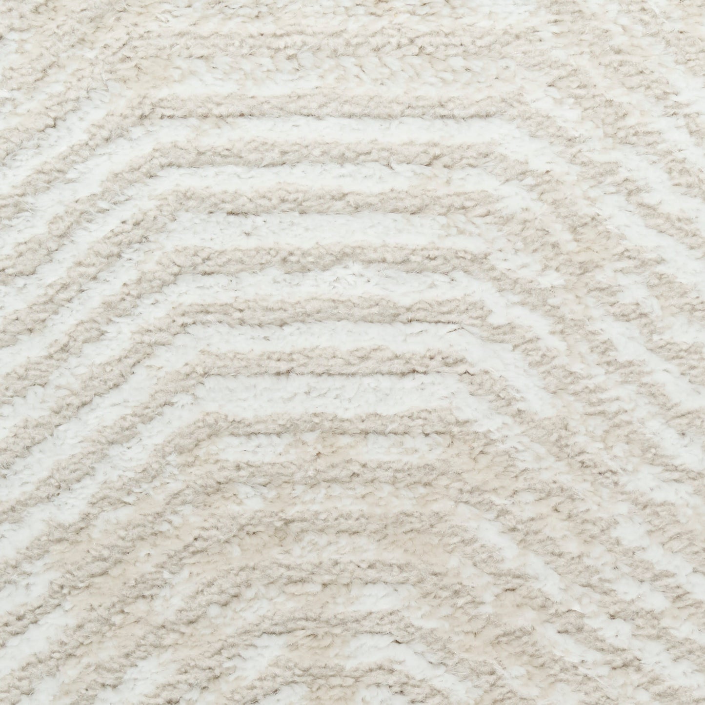 Cream shag rug with raised chevron pattern; soft plush texture ideal for living room or bedroom decor.