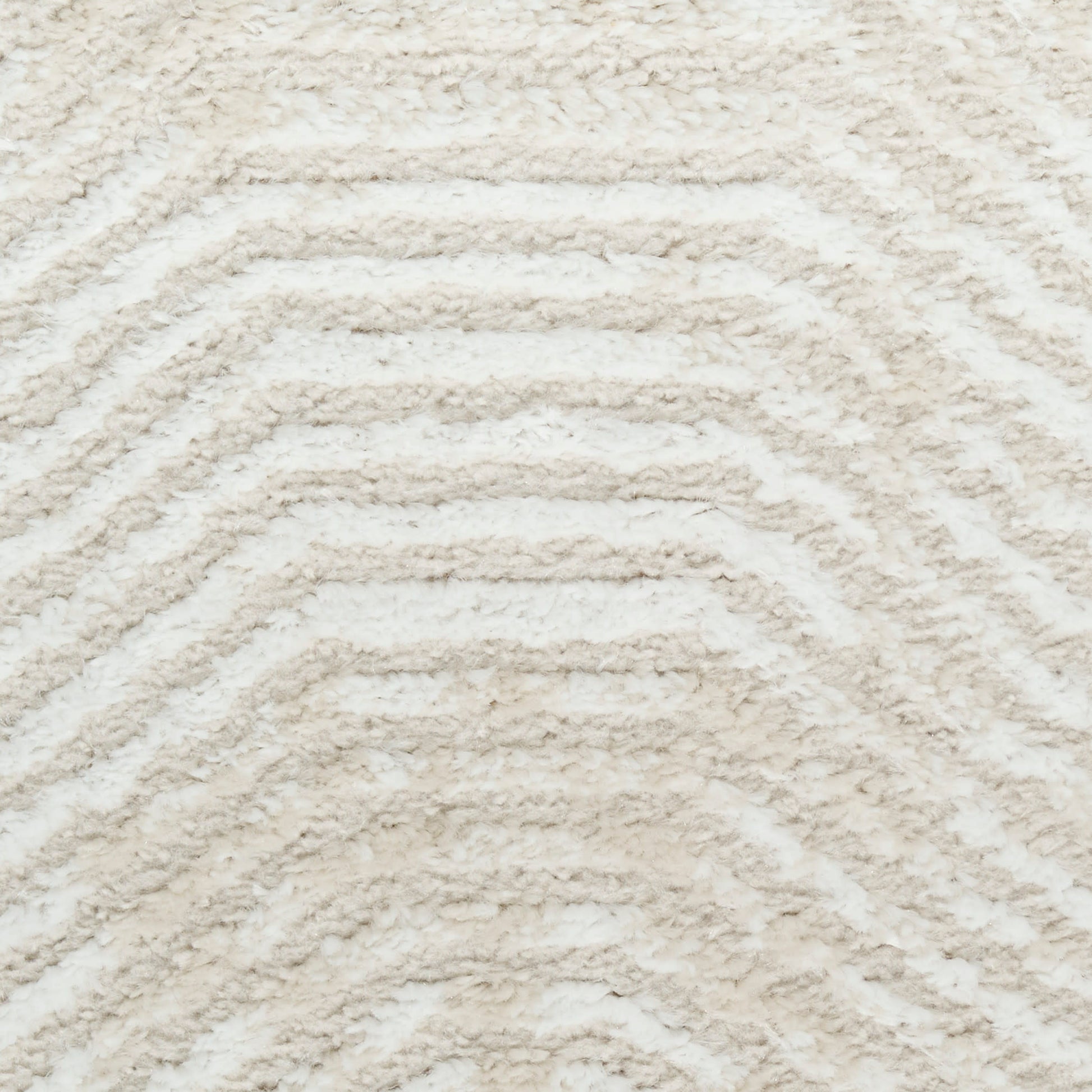 Cream shag rug with raised chevron pattern; soft plush texture ideal for living room or bedroom decor.