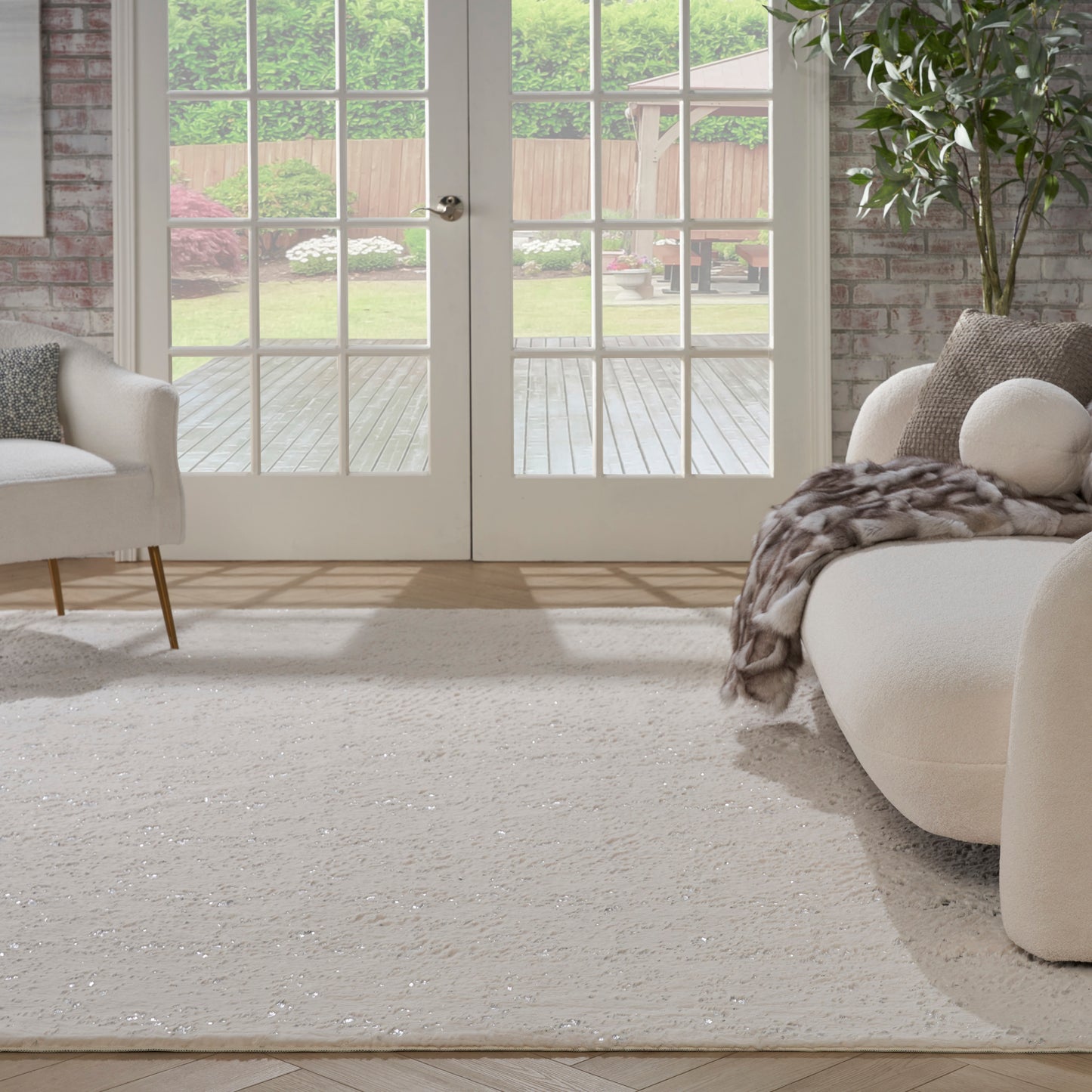 Bright living room with a beige fluffy rug (8' x 10'), and a cream curved sofa visible.