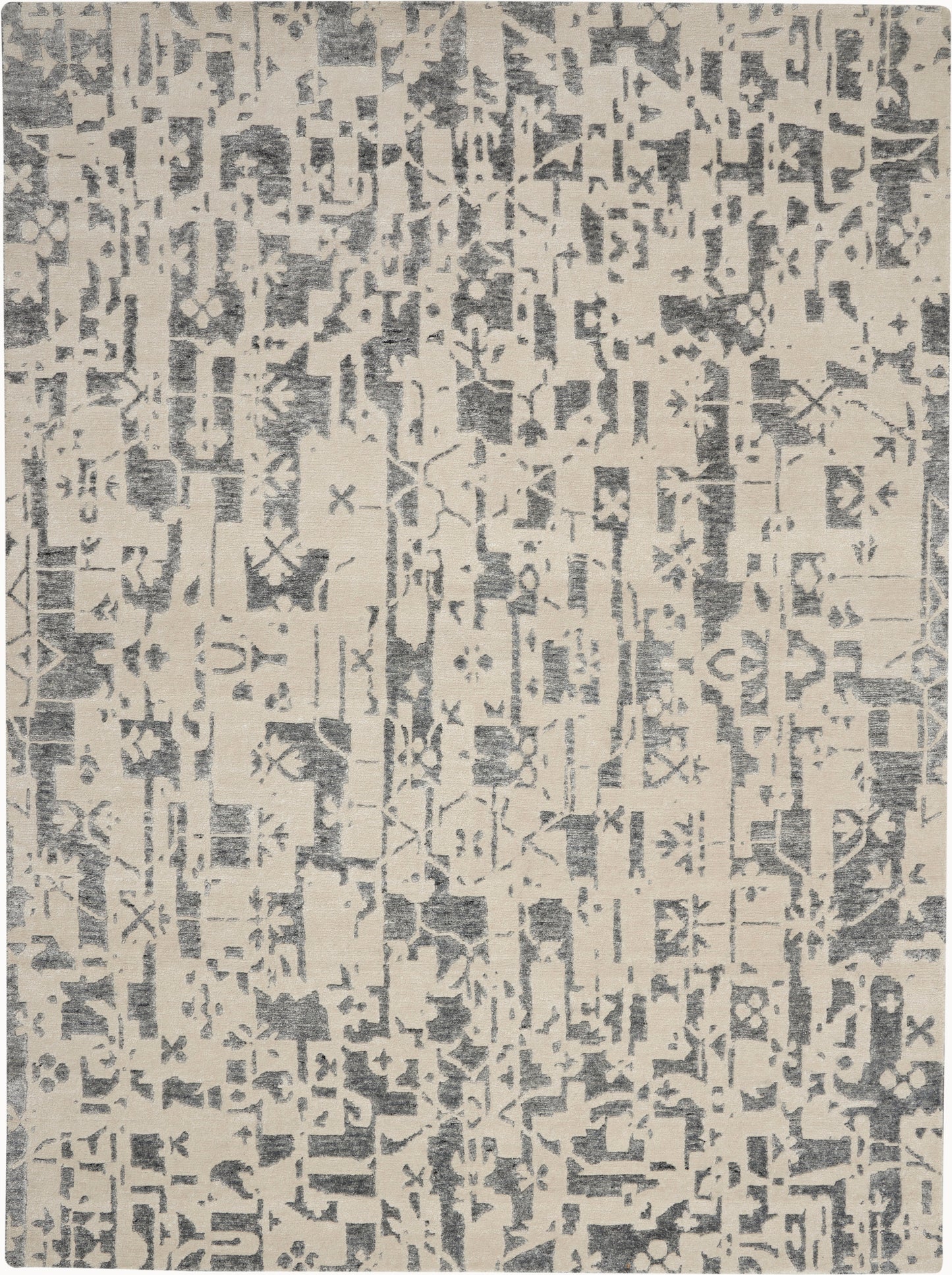 Beige rug featuring a gray distressed geometric pattern in a modern abstract block design.
