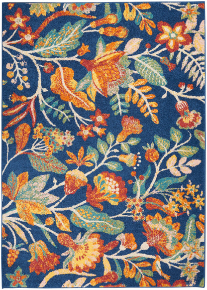 Rectangular area rug with navy background and vivid orange, teal, and yellow floral print with green leaves.