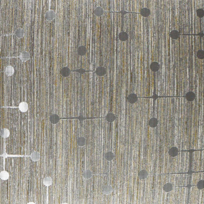 Pillow with textured fabric featuring metallic gold threads and a dotted circuit-like pattern of gray circles linked by short lines