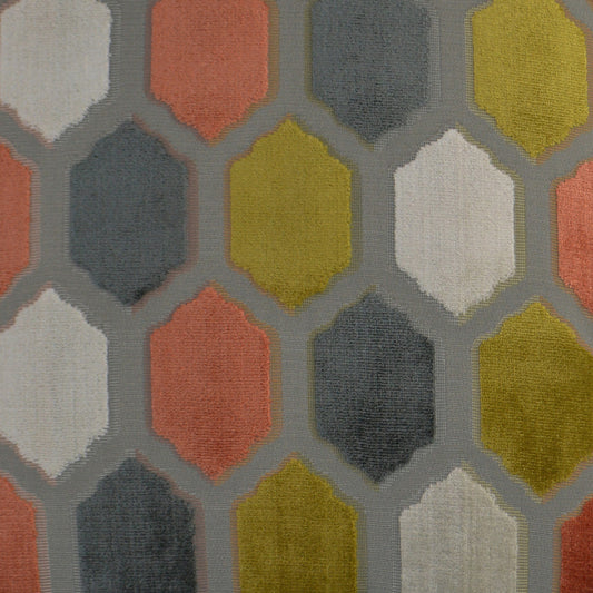 Geometric hexagon-patterned rug with coral, mustard, navy, gray and white hues on a light gray background.