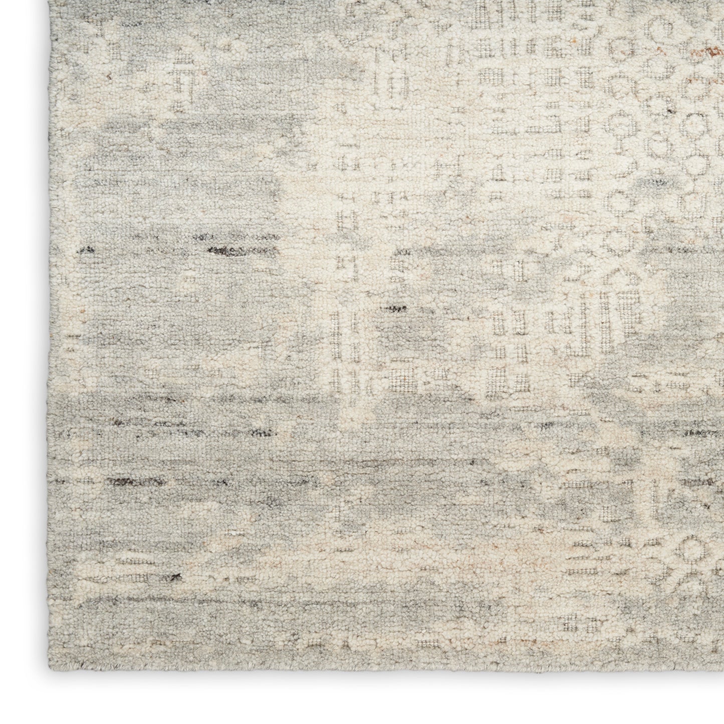Neutral beige-gray distressed area rug with subtle geometric motifs, soft textured pile, rectangular living room rug.