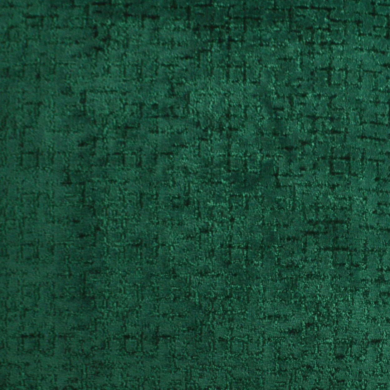 Emerald green velvet fabric close-up with plush nap and subtle sheen.