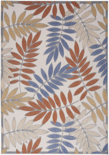 Leaf-pattern rug with blue, rust-orange, and beige leaves on a light backdrop; woven texture with bordered edges.
