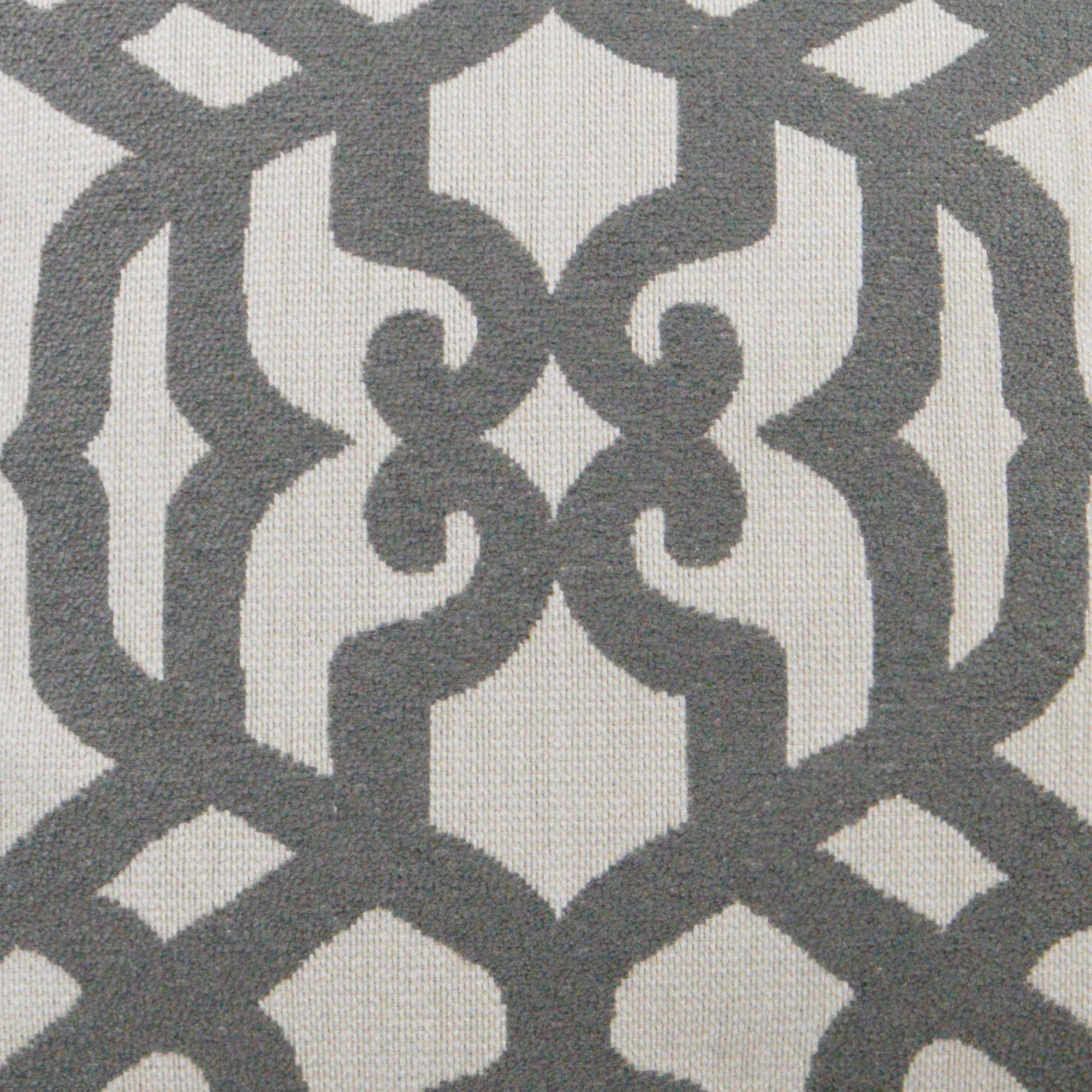 Grey interlocking geometric damask pattern on cream background; upholstery fabric for cushions or drapes.