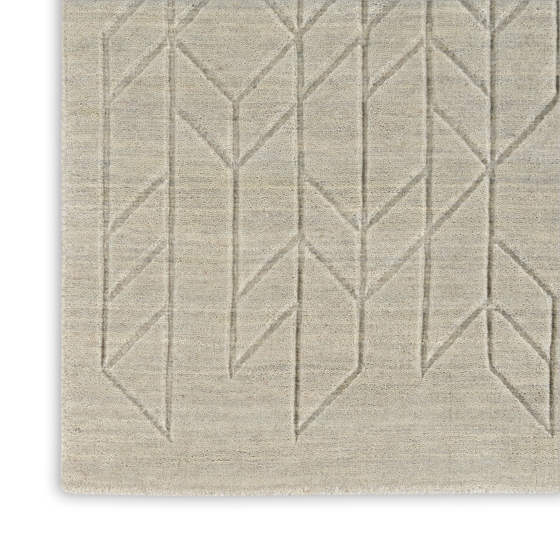 Beige rectangular rug with subtle taupe geometric chevron pattern; woven texture.