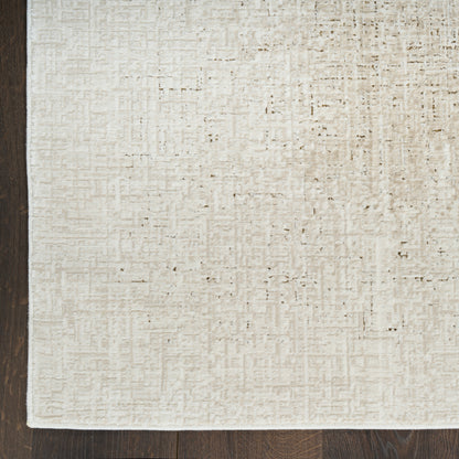Beige textured area rug with subtle grid pattern on dark hardwood floor.