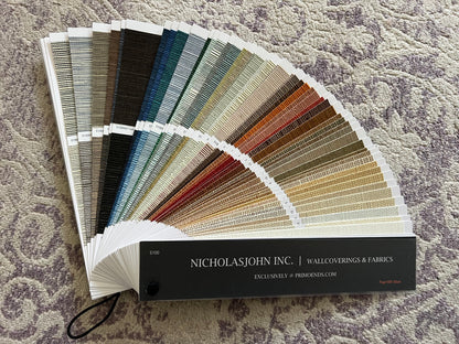Color swatch book from NicholasJohn Inc. on a textured surface