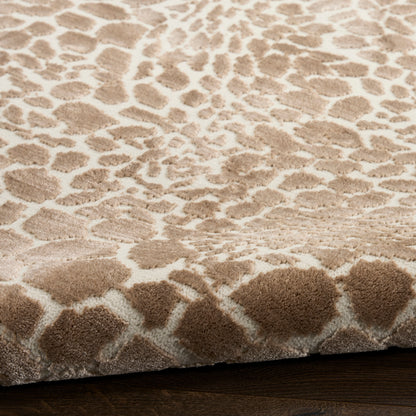 Beige plush area rug with irregular taupe spots; modern animal-print style.